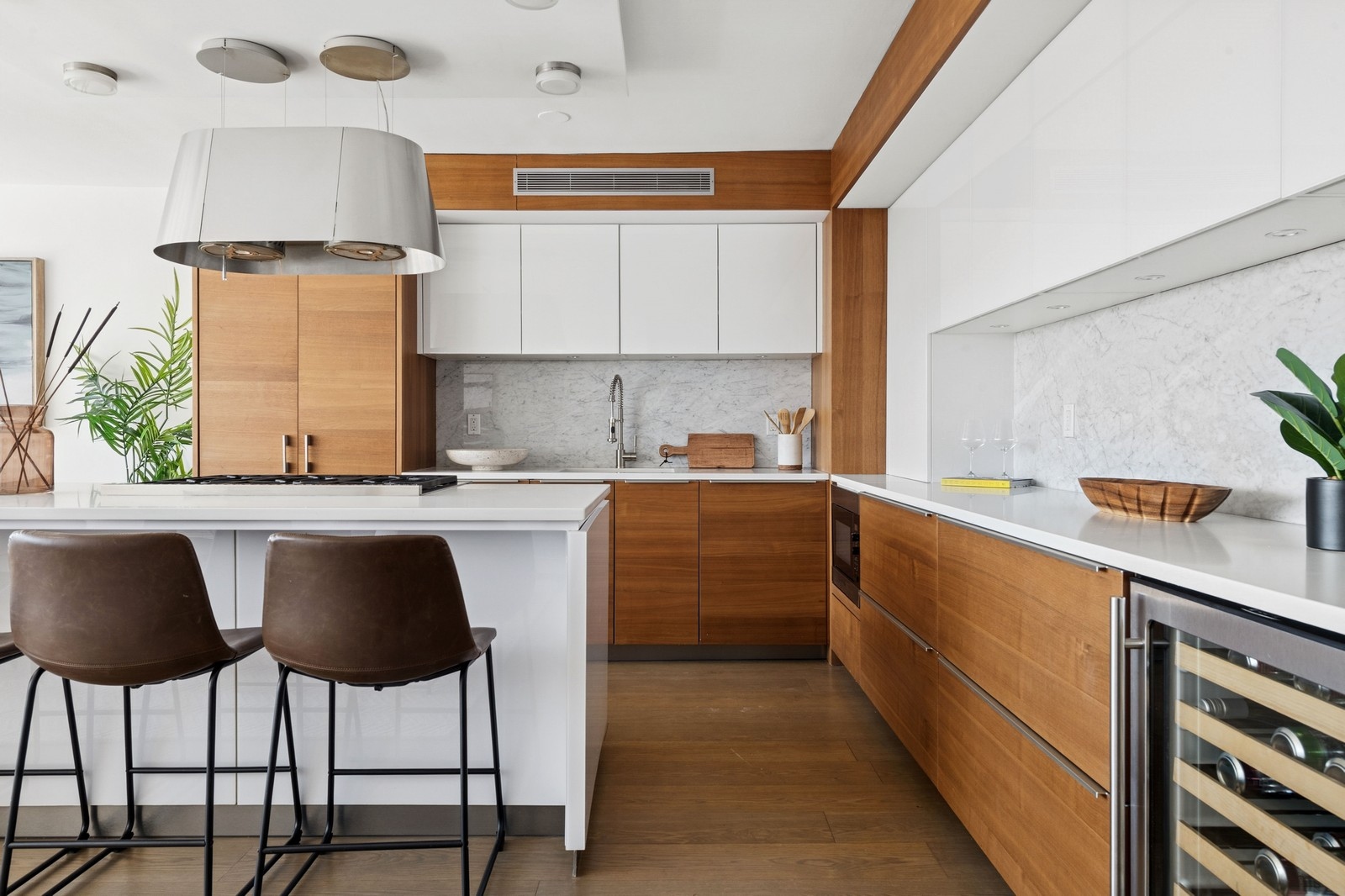 205 3rd Avenue, Unit 21H Manhattan, NY 10003 - Photo 2 of 17 a kitchen with a table chairs sink and cabinets