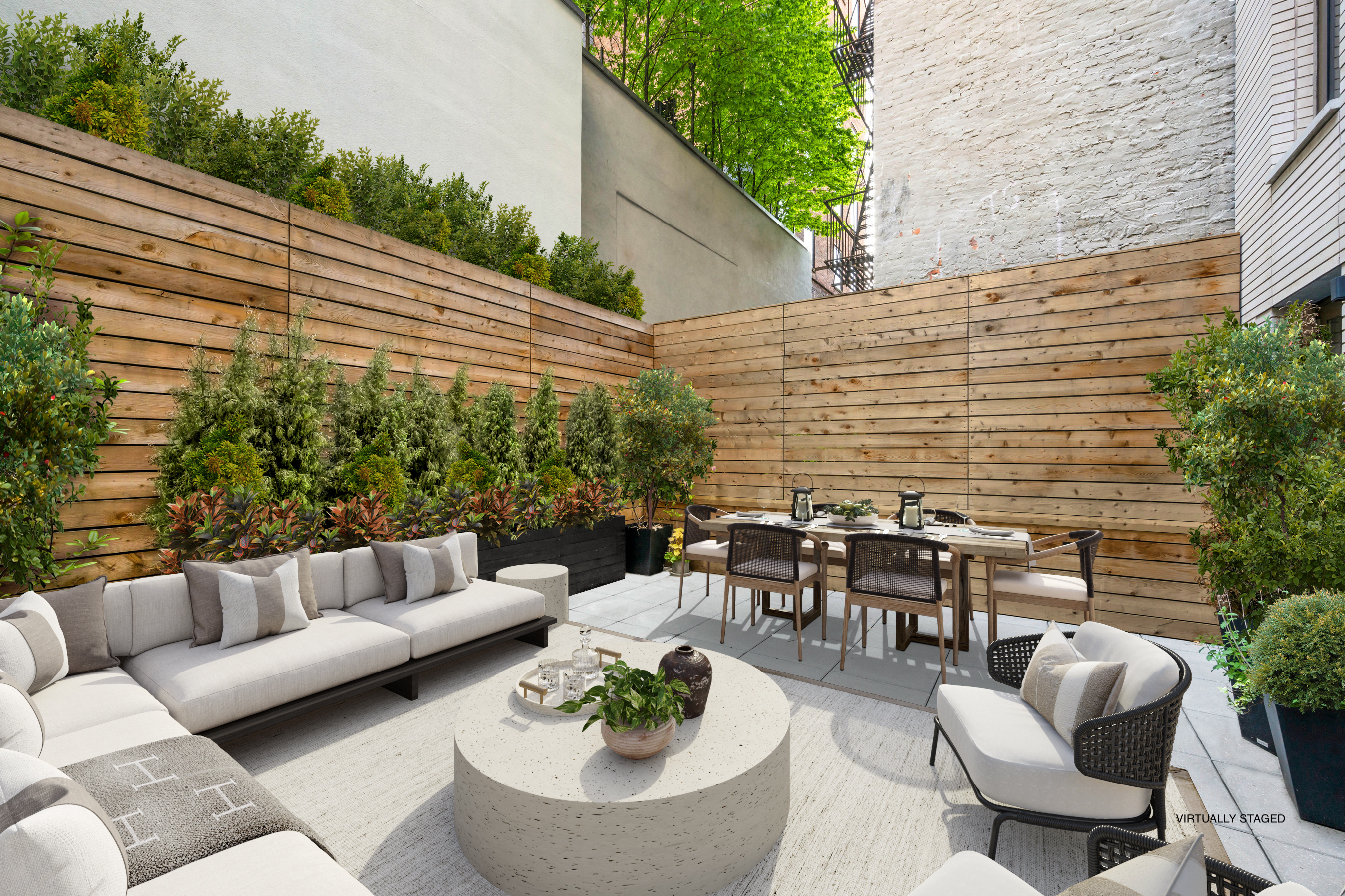 142 West 19th Street, Unit TH Manhattan, NY 10011 - Photo 2 of 10 a view of a patio with couches table and chairs and potted plants