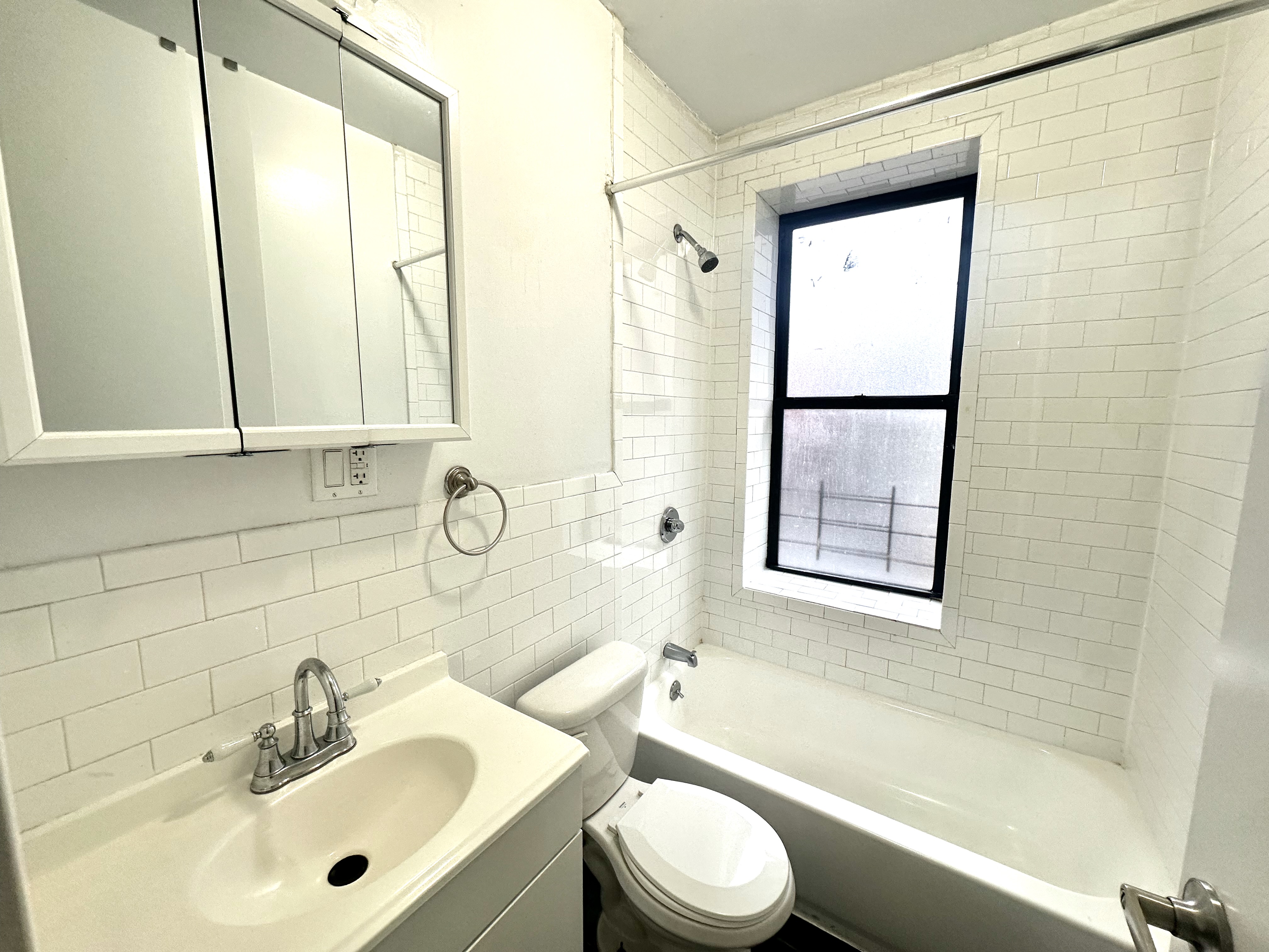 517 West 161st Street, Unit 32 Manhattan, NY 10032 - Photo 5 of 5 a bathroom with a sink toilet and shower