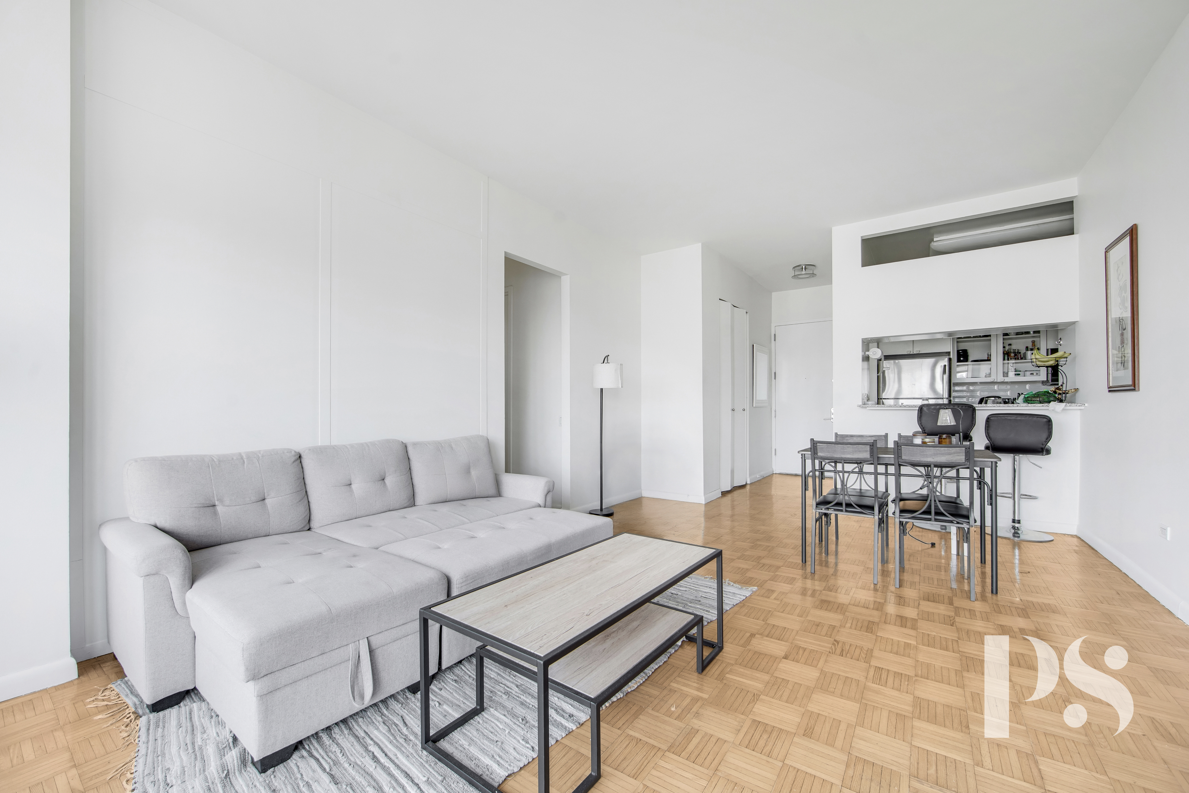 200 East 32nd Street, Unit 33C Manhattan, NY 10016 - Photo 5 of 12 a living room with furniture a dining table and a fireplace