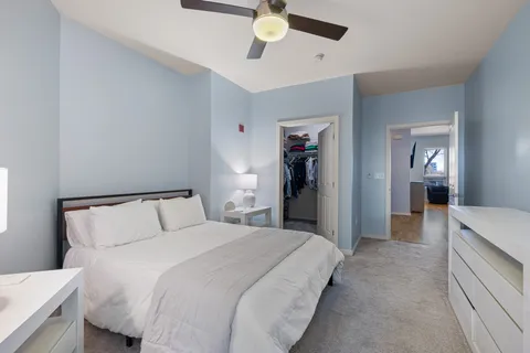 a bedroom with a bed and a chandelier