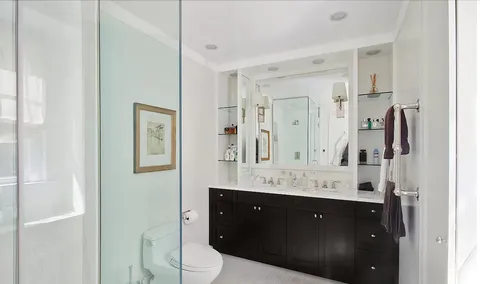 a bathroom with a sink vanity granite and a mirror