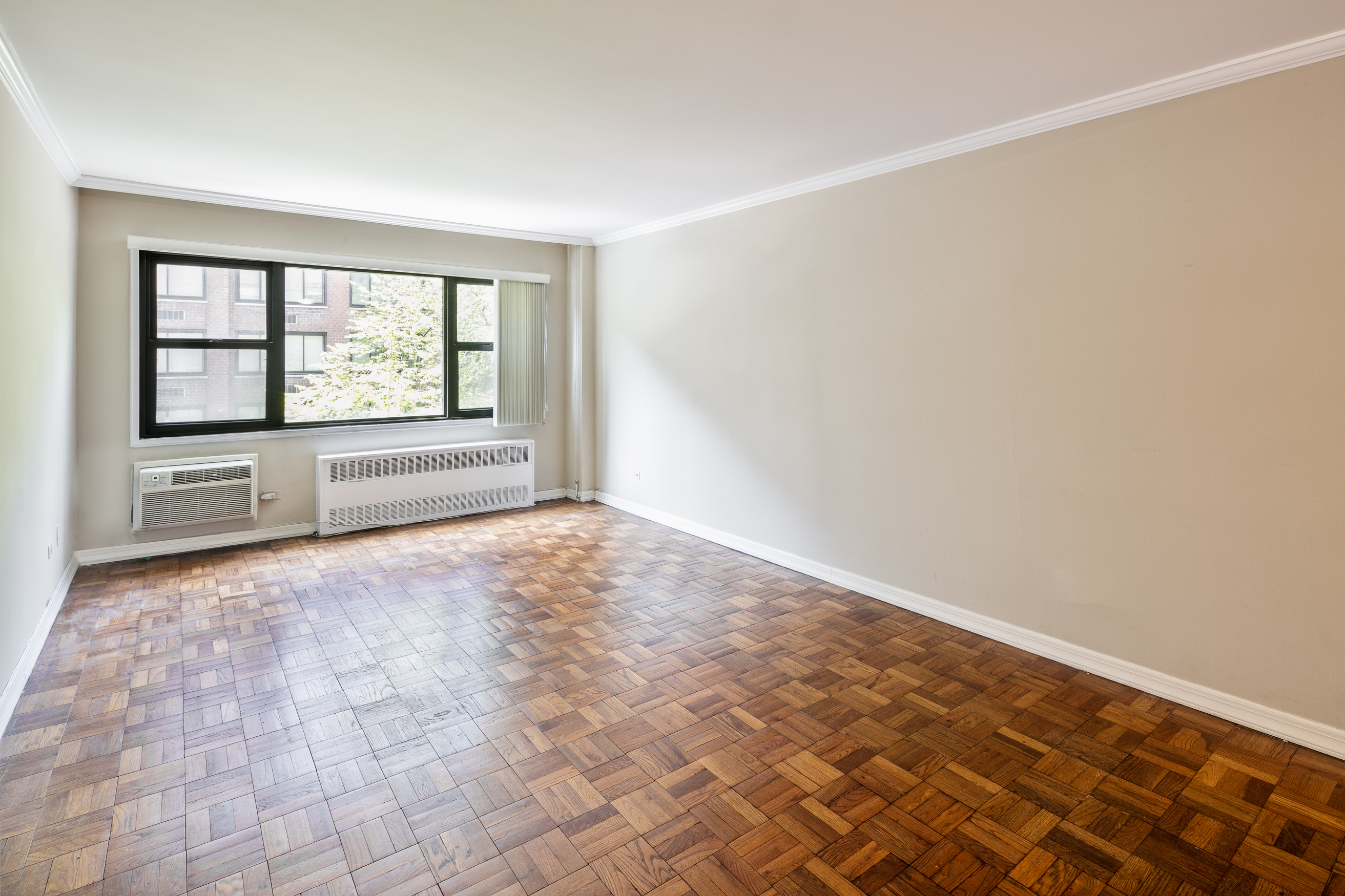 335 East 51st Street, Unit 2D Manhattan, NY 10022 - Photo 2 of 11 a view of an empty room with a window