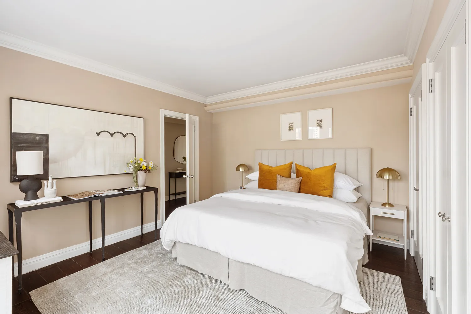 a bedroom with a bed and dresser with mirror