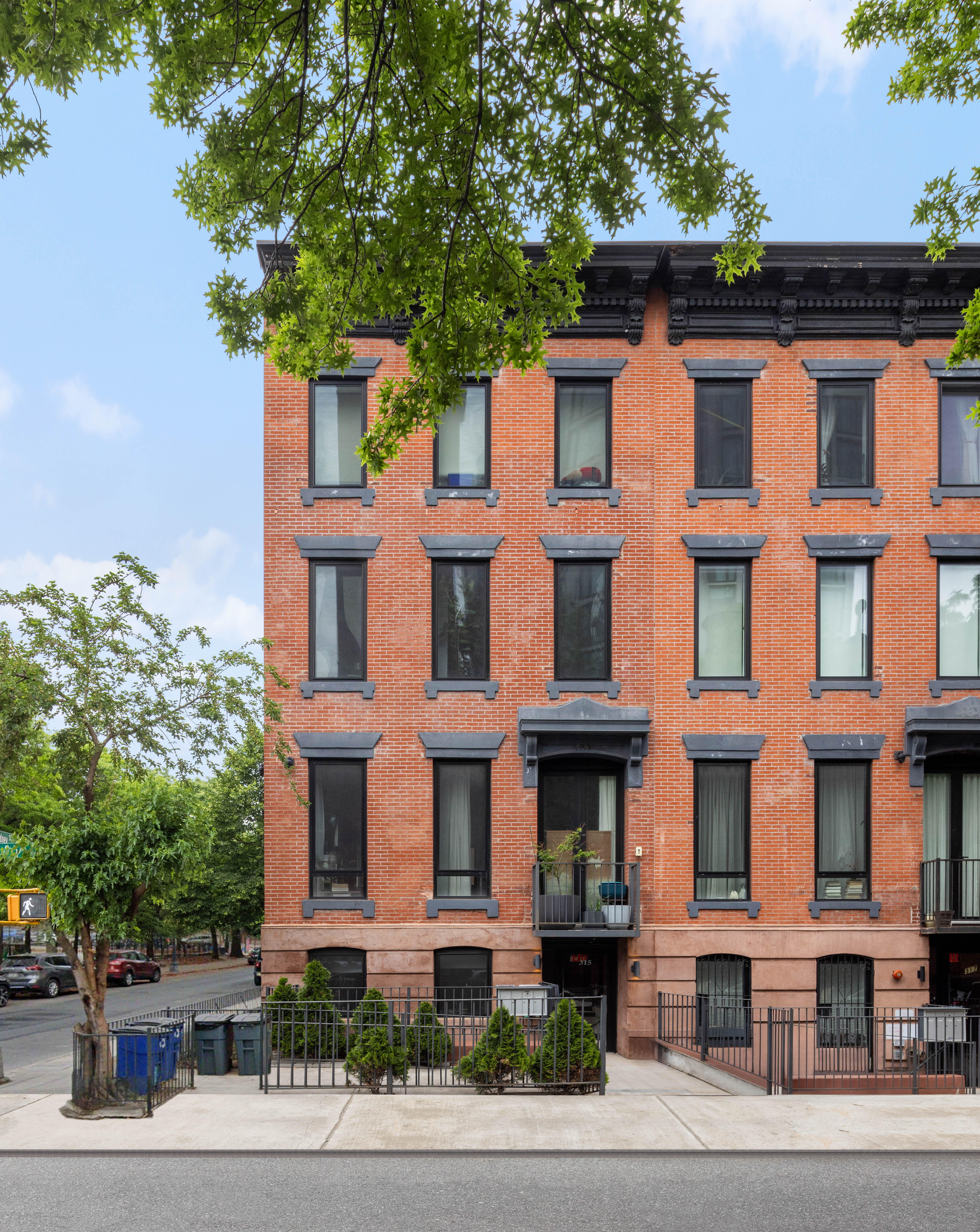 315 South 5th Street, Unit 2 Brooklyn, NY 11211 - Photo 9 of 10 a front view of a residential apartment building with a yard