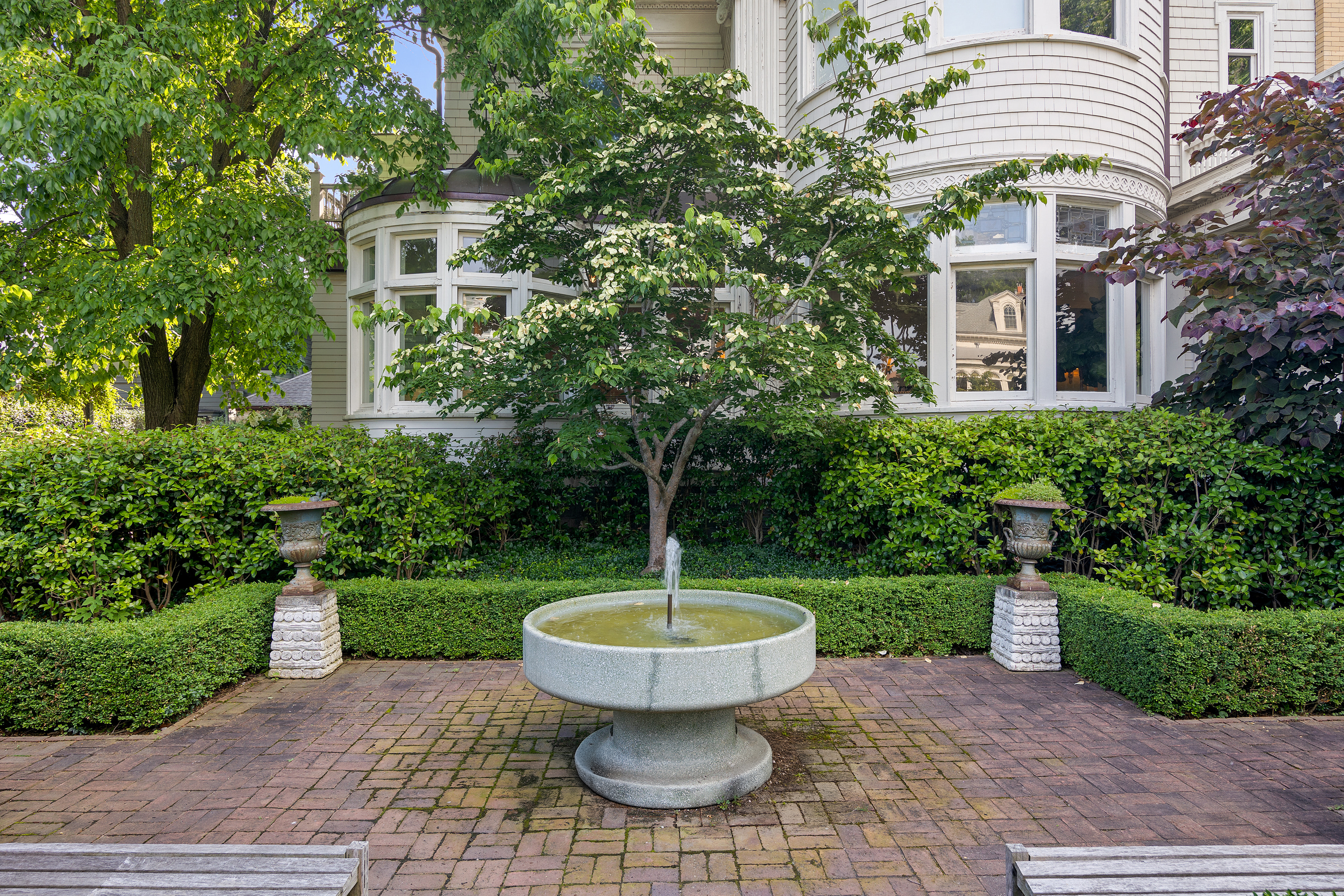 1440 Albemarle Road Brooklyn, NY 11226 - Photo 34 of 39 a view of a patio with a table and chairs potted plants and a large tree