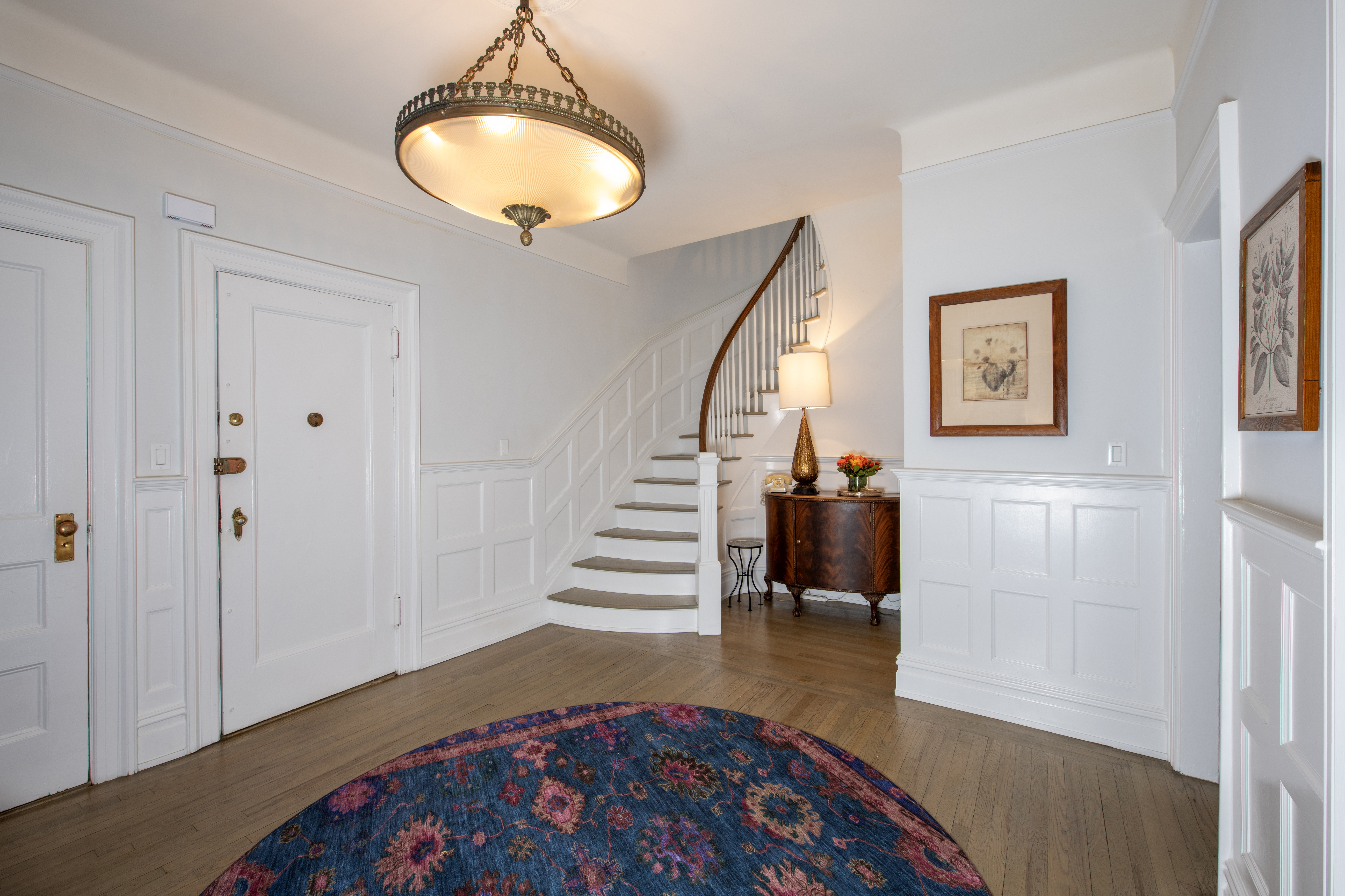 194 Riverside Drive, Unit 5C/6C Manhattan, NY 10025 - Photo 2 of 26 a bedroom with wooden floor and a chandelier