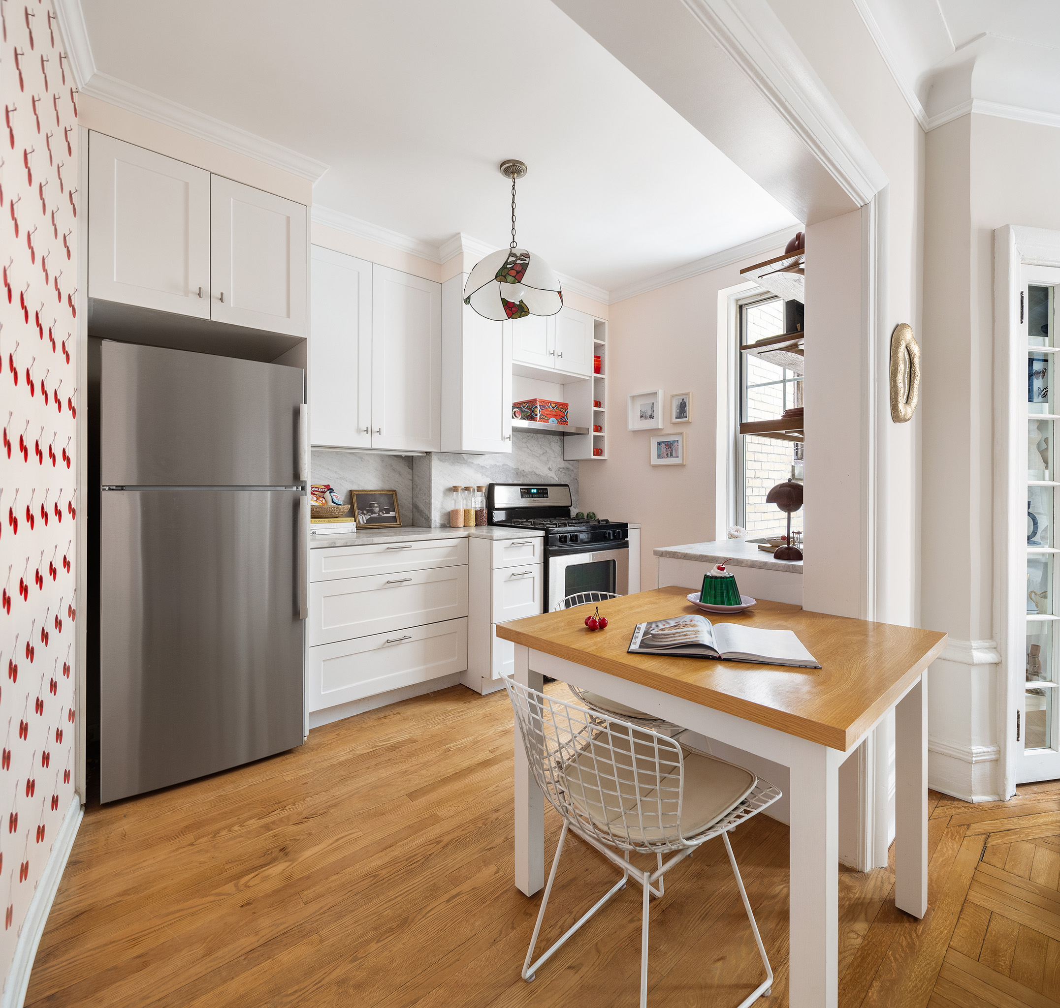 125 Prospect Park West, Unit 2E Brooklyn, NY 11215 - Photo 8 of 14 a kitchen with granite countertop white cabinets and stainless steel appliances