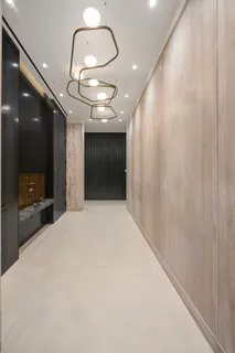 a large room with a large mirror and a chandelier fan