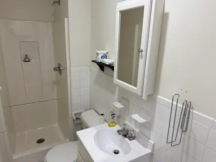 a kitchen with granite countertop a refrigerator stove and sink