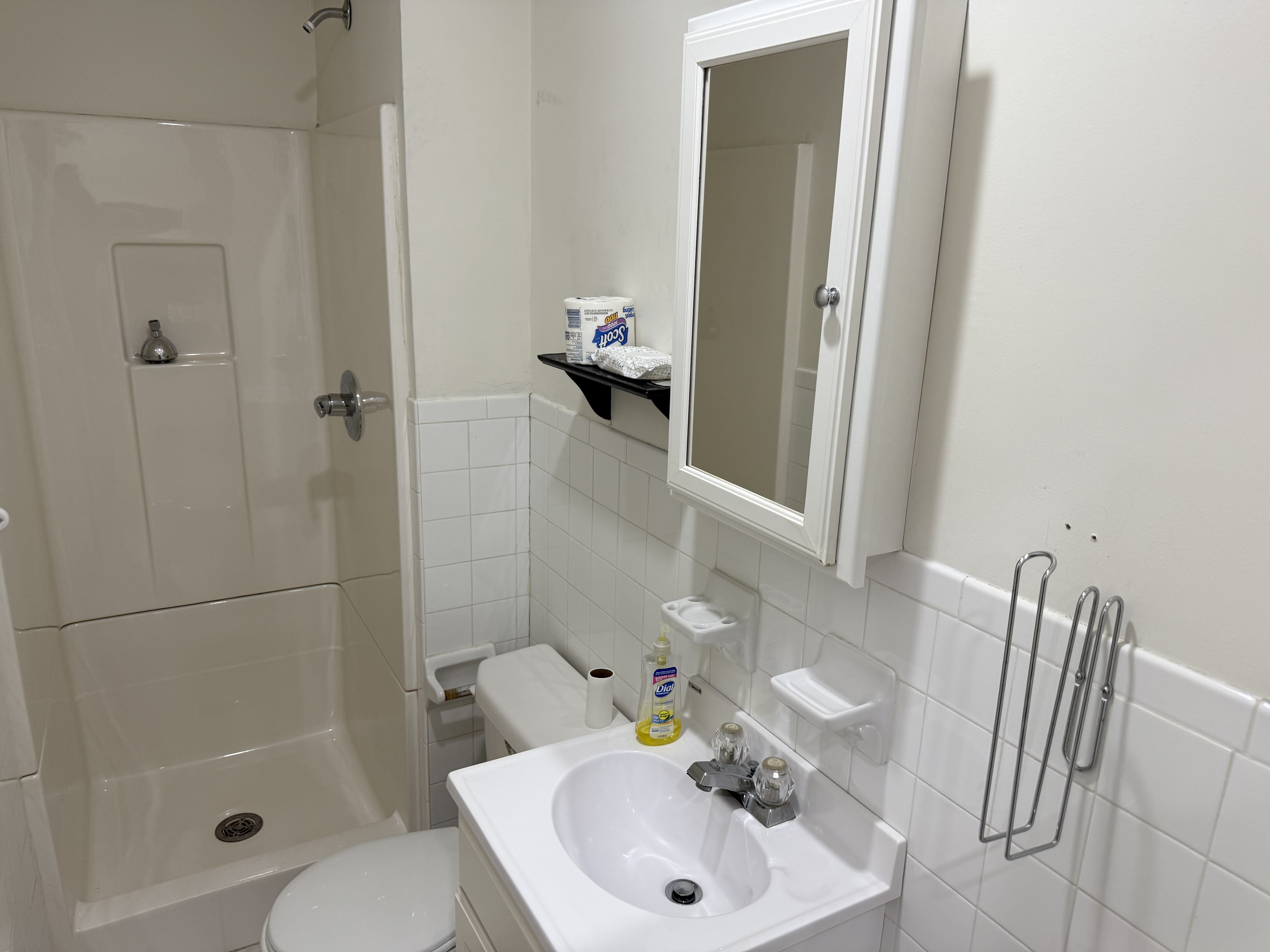 599 60th Street West New York, NJ 07093 - Photo 11 of 17 a bathroom with a sink a toilet and shower