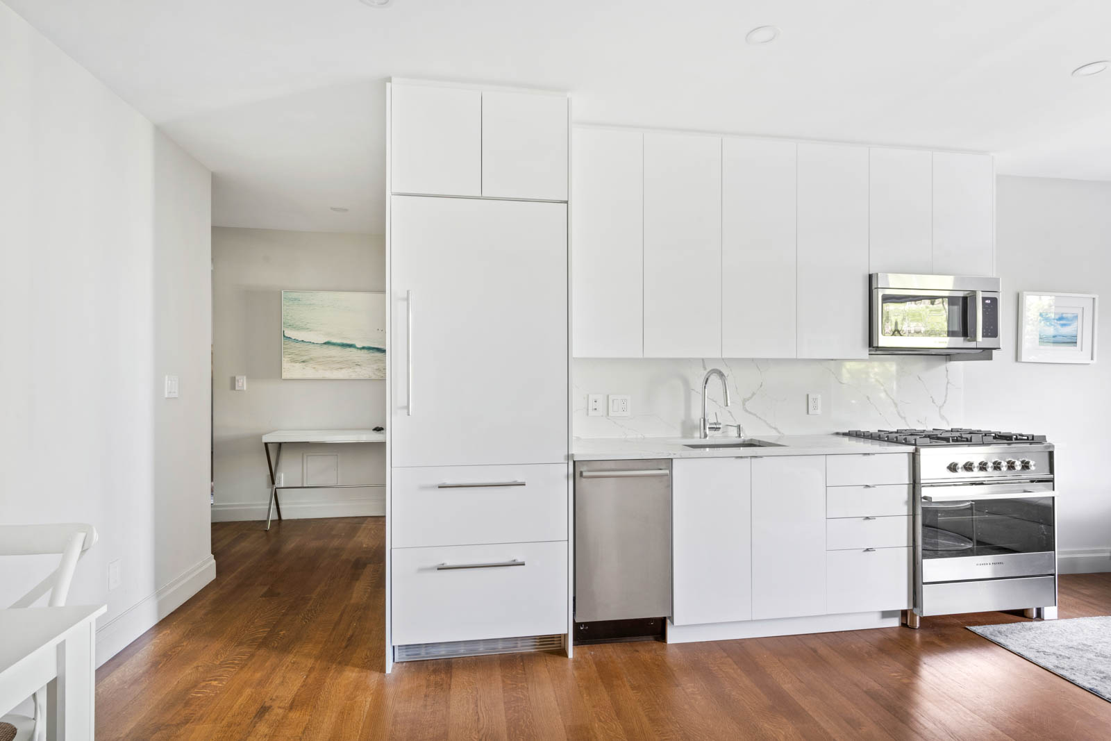 520 East 90th Street, Unit 3M Manhattan, NY 10128 - Photo 4 of 11 a kitchen with granite countertop a refrigerator and a stove