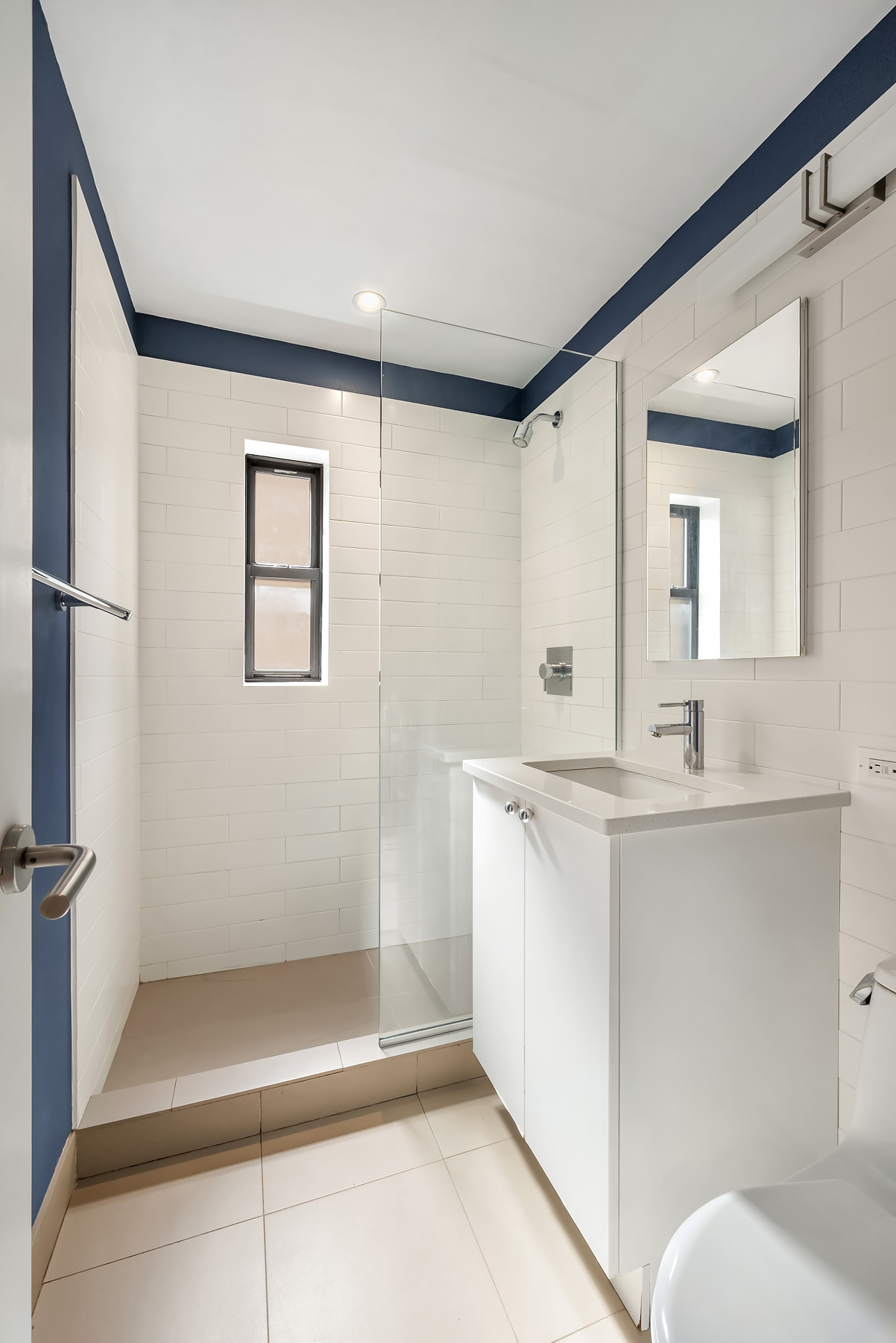 319 West 18th Street, Unit 4H Manhattan, NY 10011 - Photo 5 of 6 a bathroom with a sink a toilet and shower