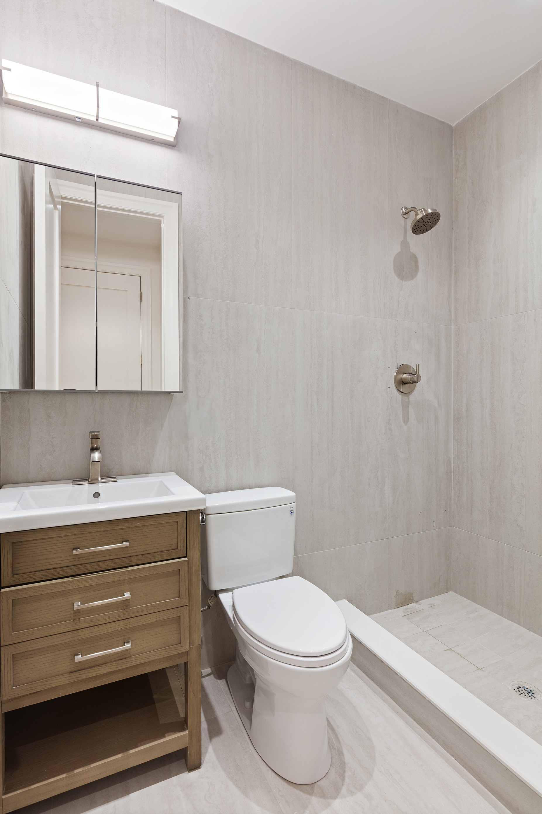 80 7th Avenue, Unit 2 Brooklyn, NY 11217 - Photo 4 of 8 a bathroom with a sink a toilet and shower