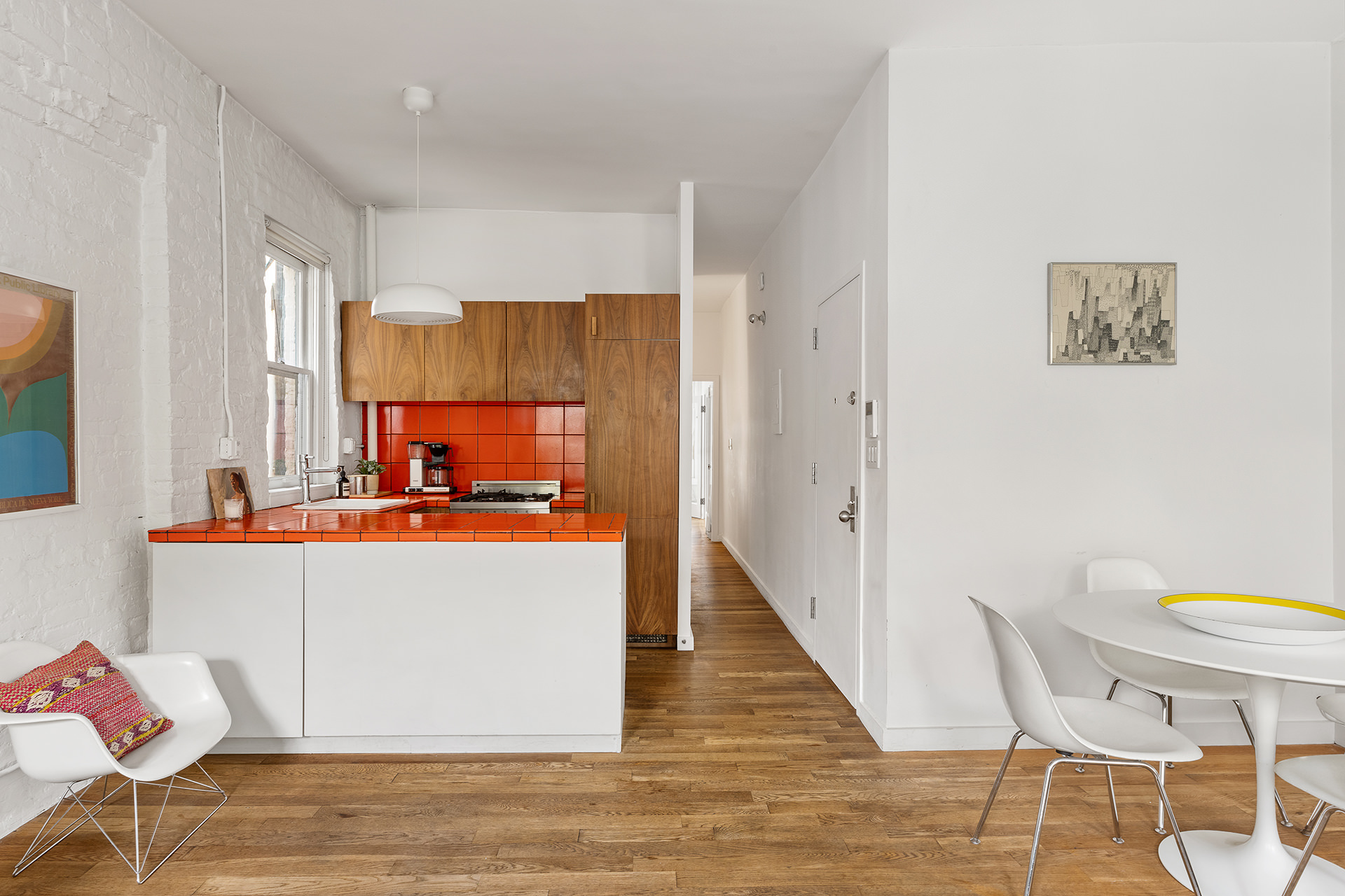 305 East 4th Street, Unit 2 Manhattan, NY 10009 - Photo 2 of 11 a view of kitchen with stainless steel appliances wooden floor and chair