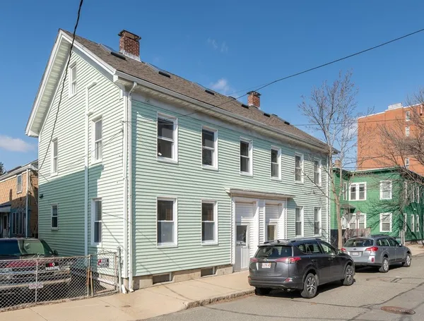 a car parked in front of a white building