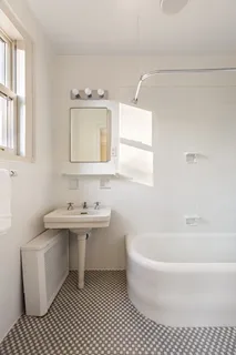 a bathroom with a sink a toilet and mirror