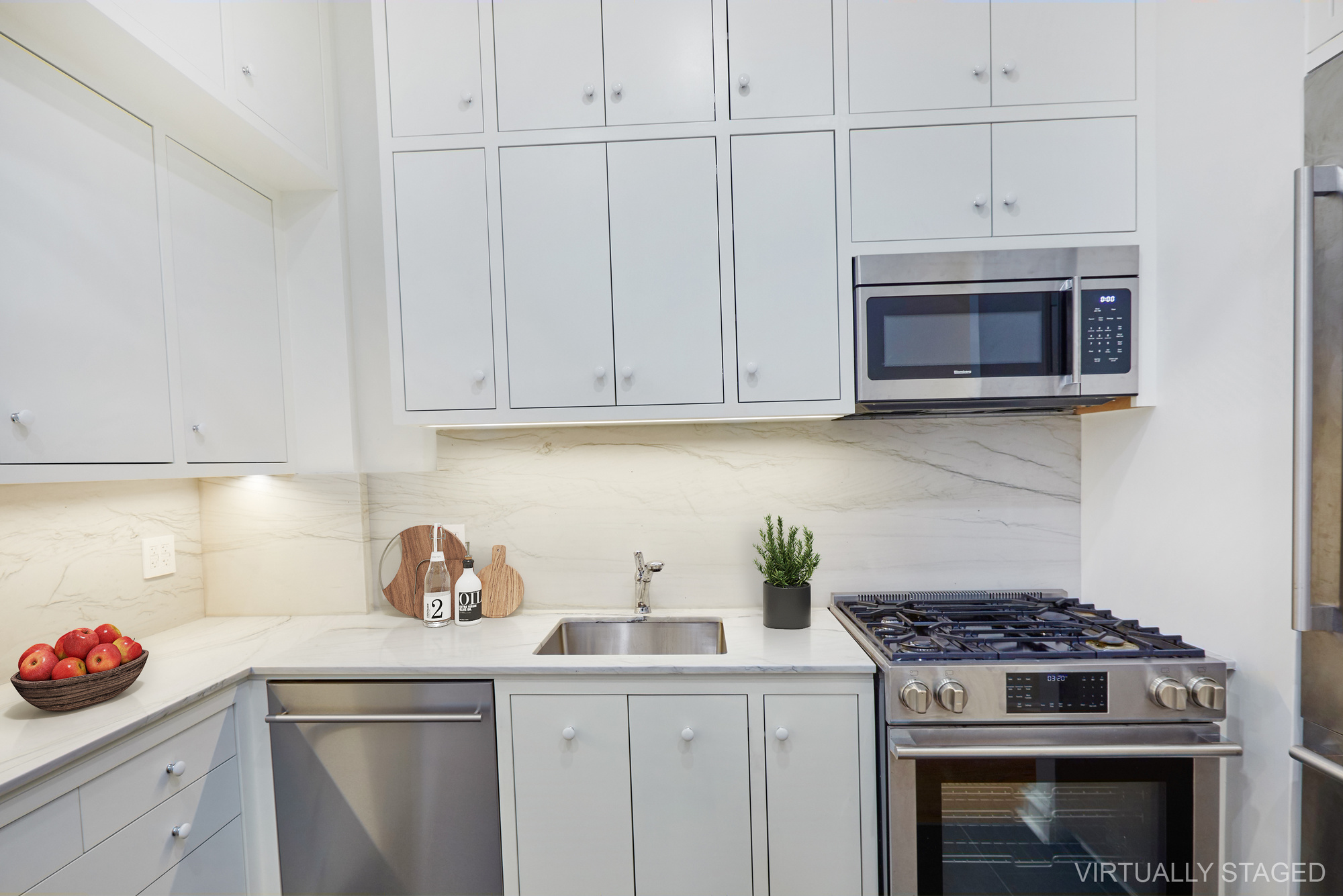 157 East 75th Street, Unit 1E Manhattan, NY 10021 - Photo 3 of 21 a kitchen with granite countertop white cabinets and stainless steel appliances