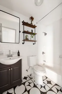 a bathroom with a sink a toilet and a mirror