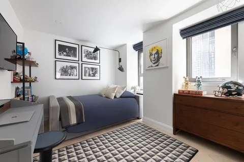 a bedroom with furniture and a window