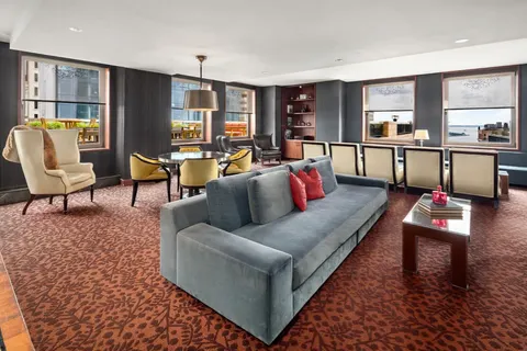 a living room with furniture and a bookshelf