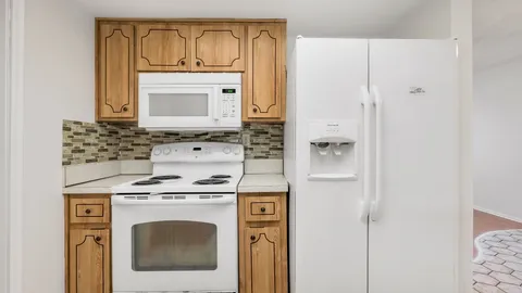 a stove top oven sitting inside of a kitchen
