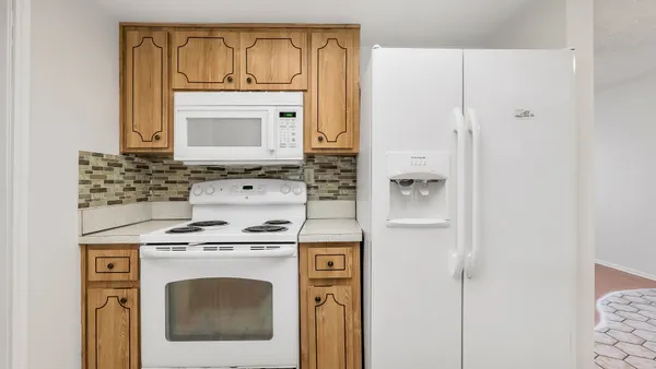 a stove top oven sitting inside of a kitchen