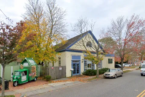 a view of a parked cars in front of house