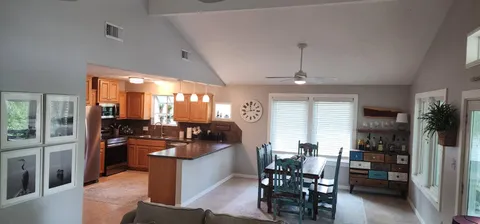 a kitchen with stainless steel appliances kitchen island granite countertop a stove and a refrigerator