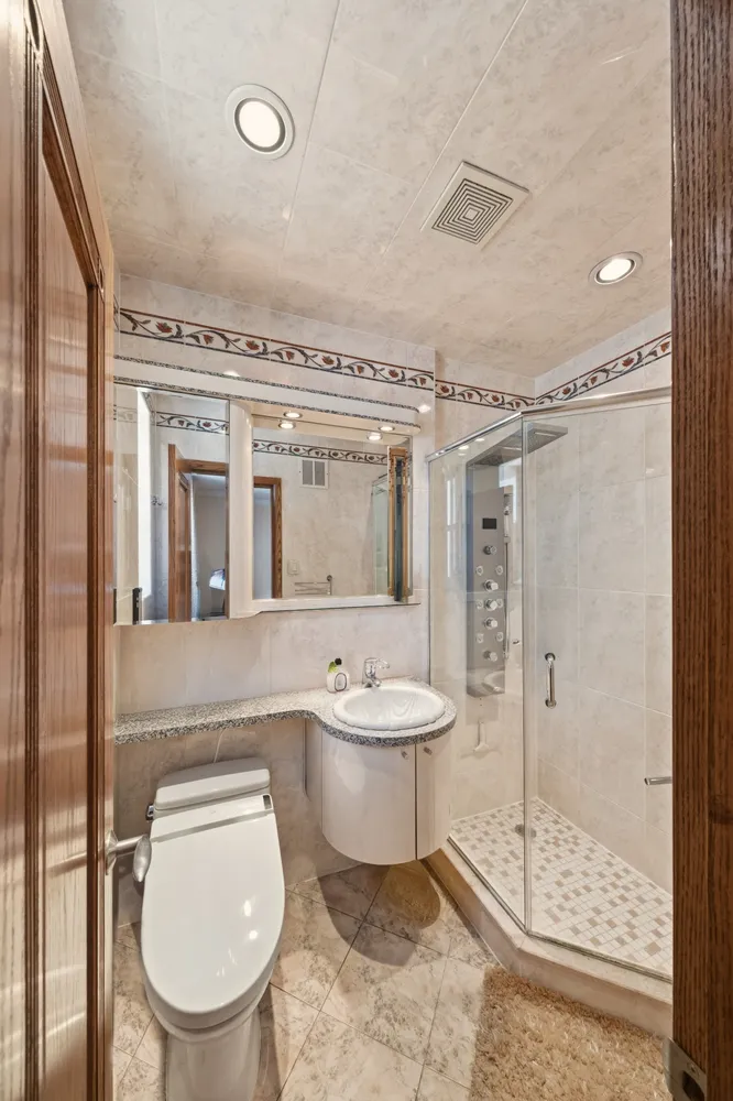 a bathroom with a toilet sink and shower