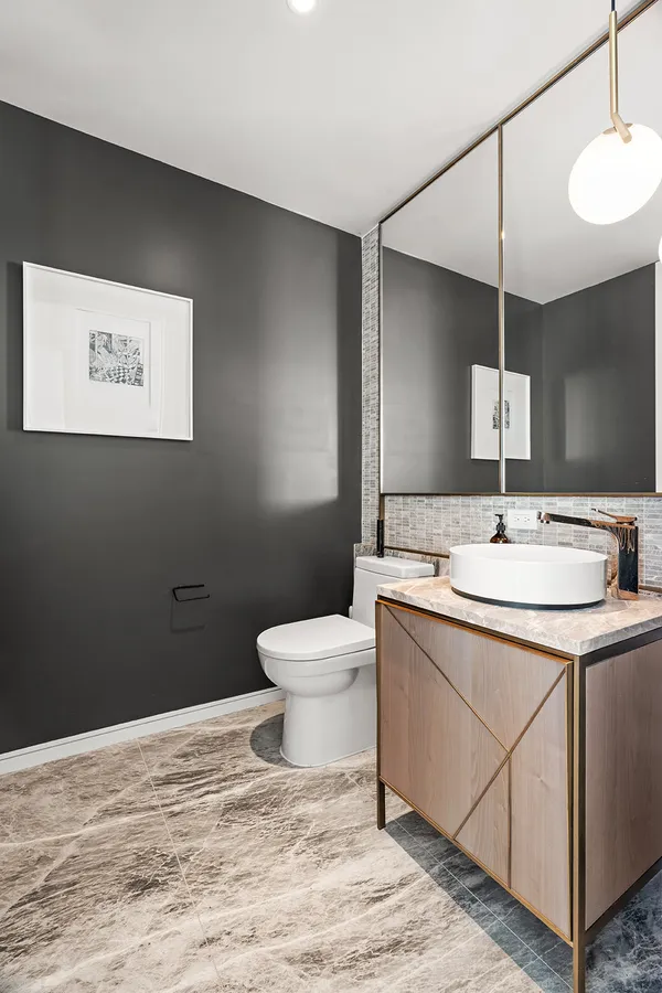 a bathroom with a sink toilet and mirror