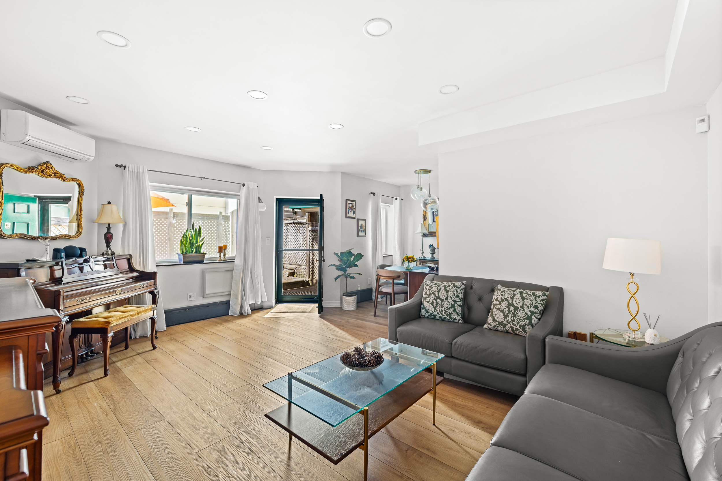 61-20 71st Avenue, Unit J1B Queens, NY 11385 - Photo 5 of 13 a living room with furniture a rug and a table