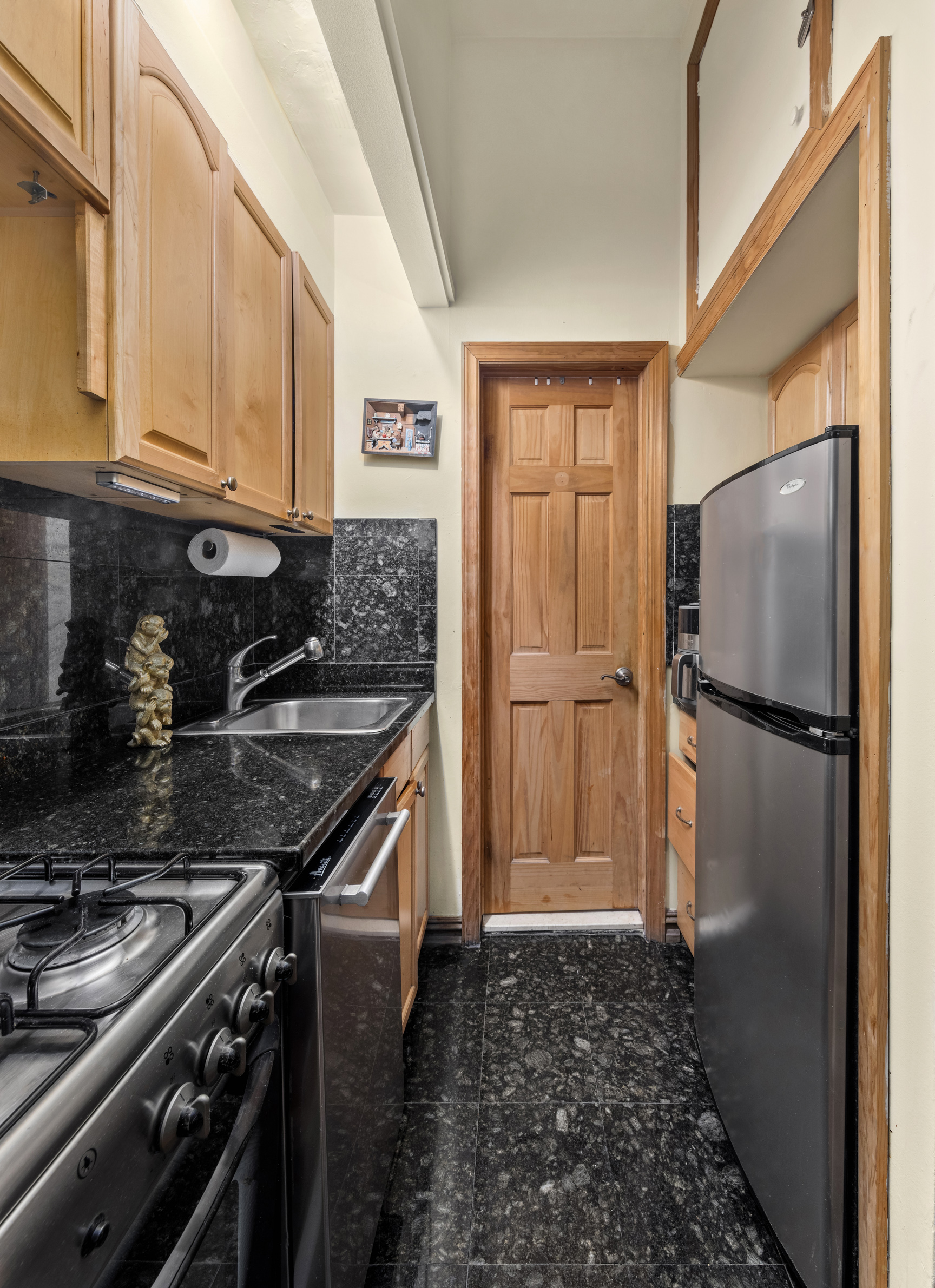 141 Sullivan Street, Unit G4 Manhattan, NY 10012 - Photo 3 of 6 a kitchen with a stove and a refrigerator