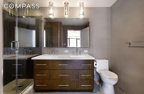 125 North 5th Street, Unit 2E Brooklyn, NY 11249 - Photo 6 of 11 a bathroom with a sink toilet and mirror