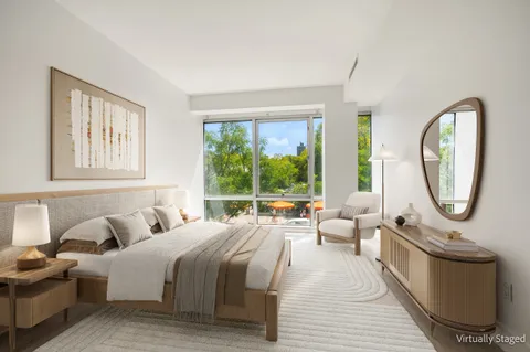 a bedroom with bed and a large window