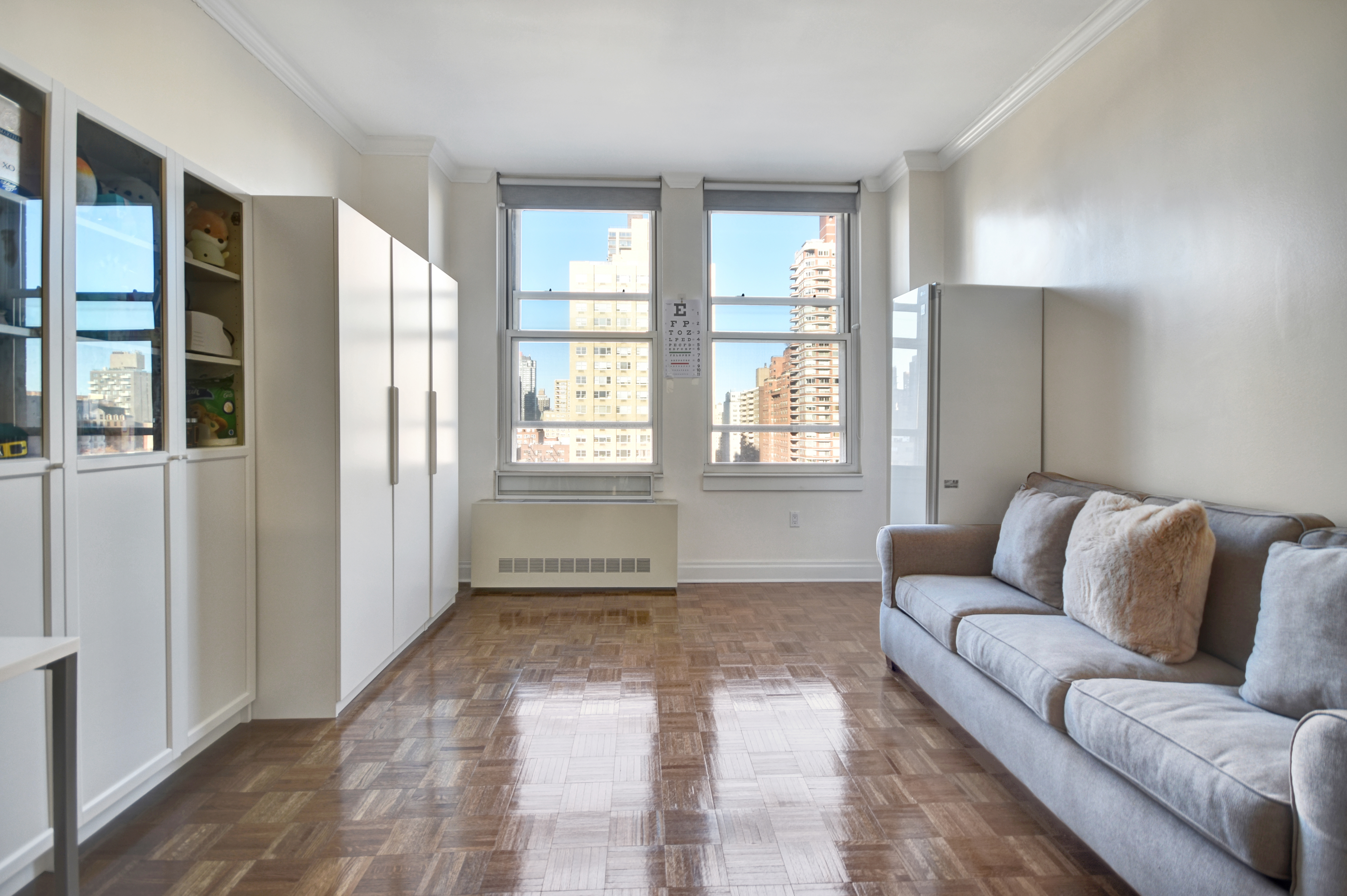 350 East 82nd Street, Unit 11B Manhattan, NY 10028 - Photo 2 of 6 a living room with furniture and a window