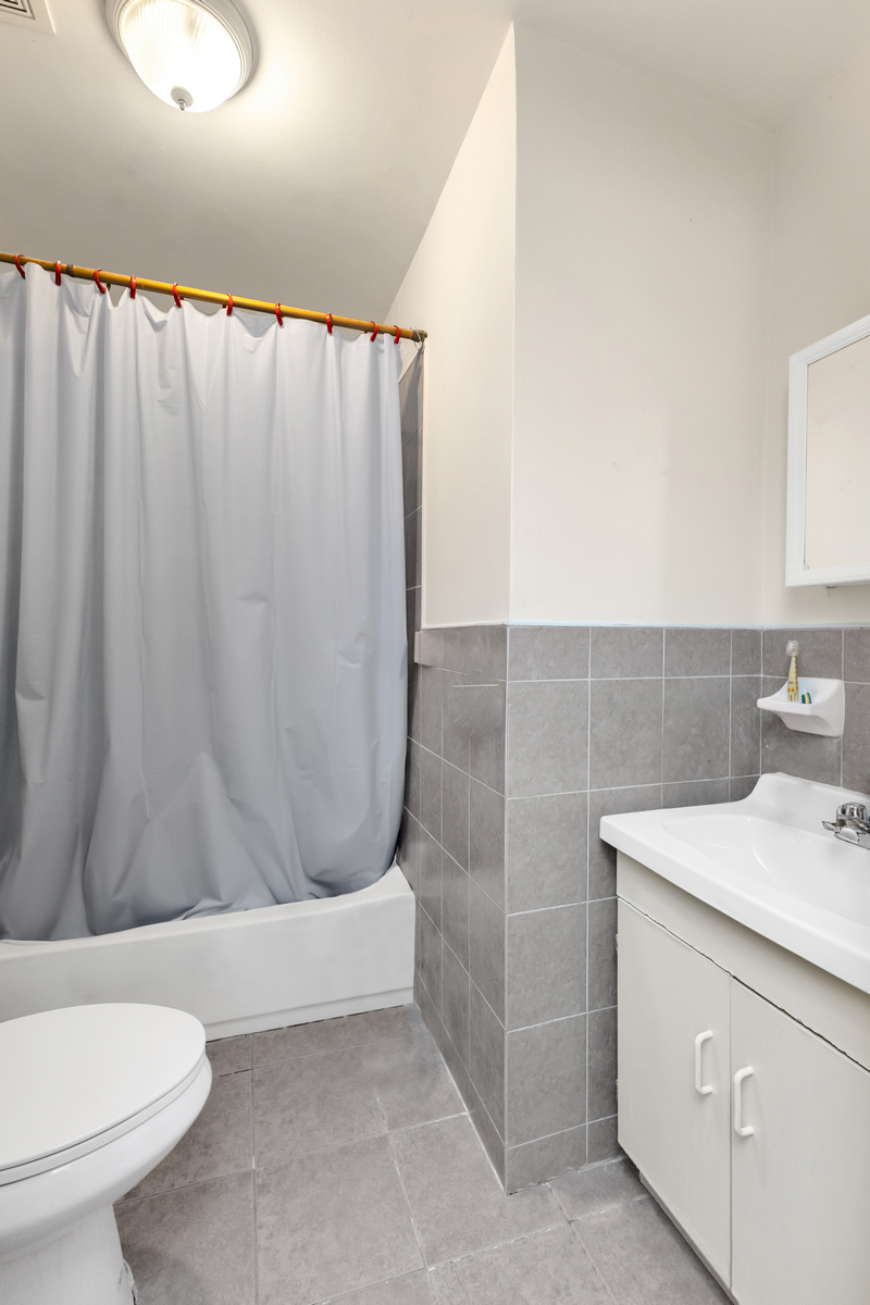 539 Quincy Street Brooklyn, NY 11221 - Photo 13 of 15 a bathroom with a sink a toilet and shower