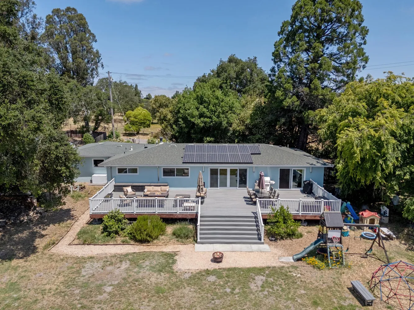 an aerial view of a house with a yard