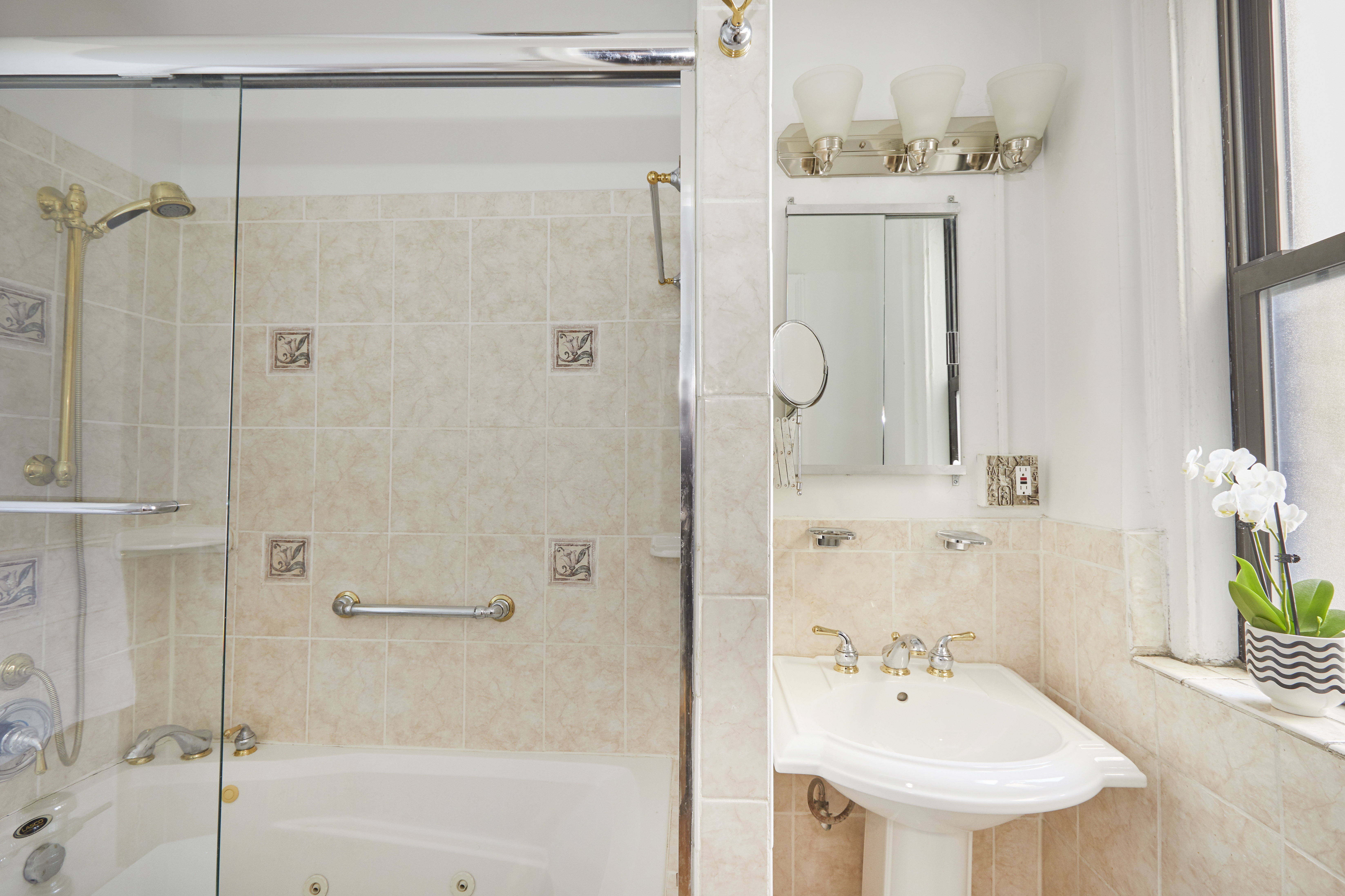 135 Eastern Parkway, Unit 9I Brooklyn, NY 11238 - Photo 12 of 17 a bathroom with a sink mirror and shower
