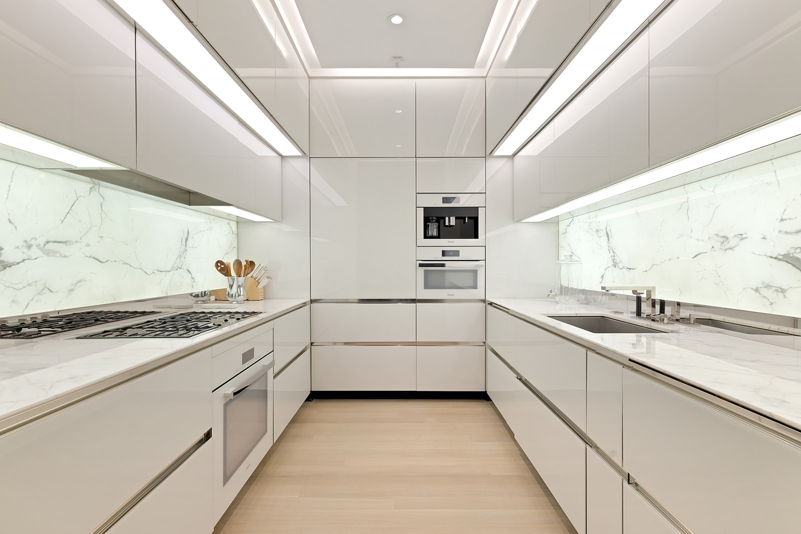 53 West 53rd Street, Unit 28D Manhattan, NY 10019 - Photo 3 of 22 a kitchen with granite countertop white cabinets and white appliances
