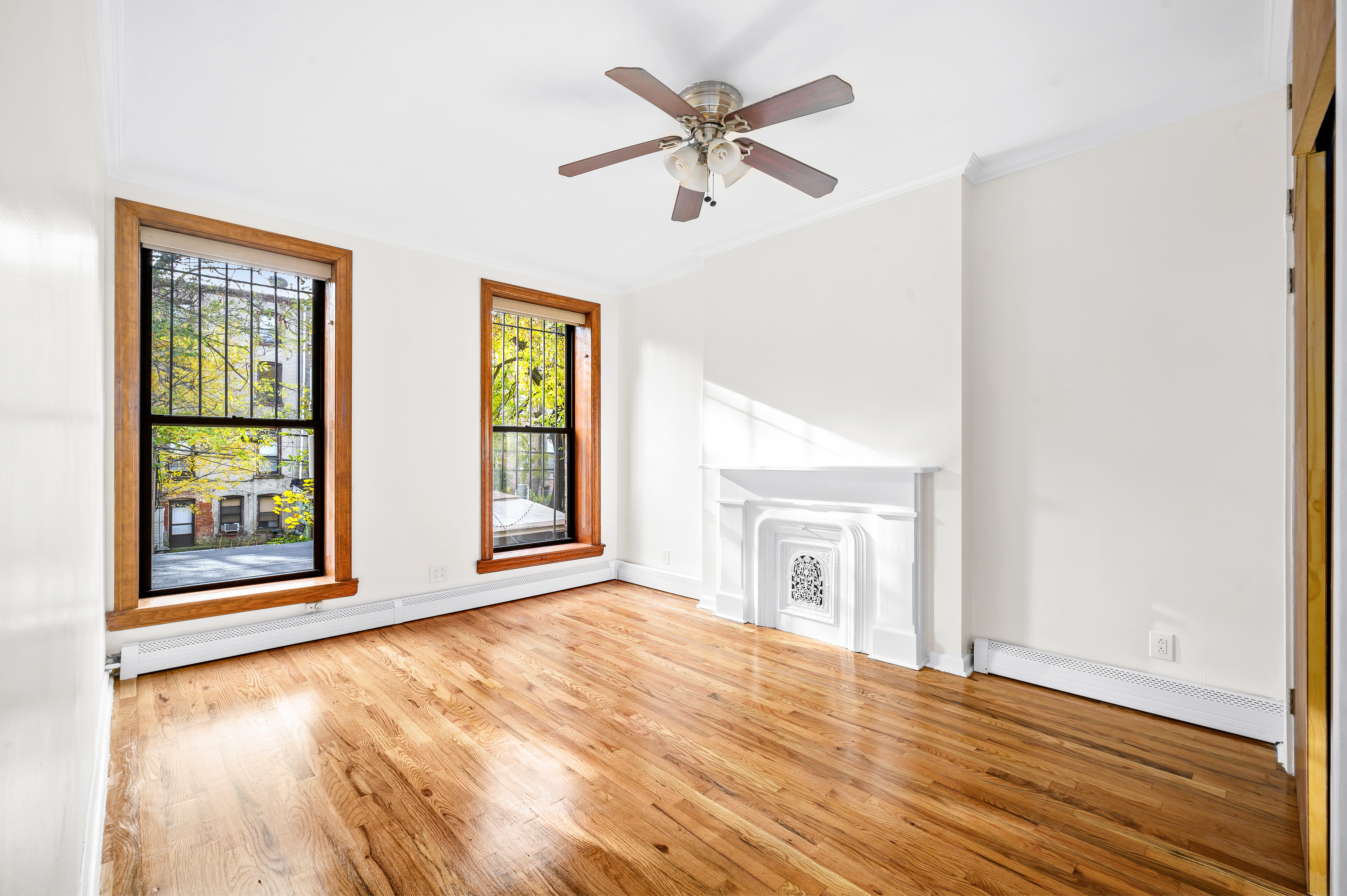 808 Lexington Avenue, Unit 1 Brooklyn, NY 11221 - Photo 3 of 8 a view of an empty room with a window and wooden floor