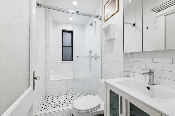a bathroom with a sink toilet and shower