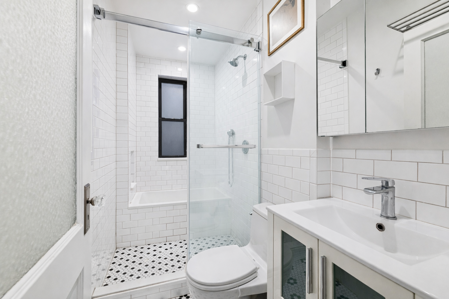 137 West 142nd Street, Unit 4B Manhattan, NY 10030 - Photo 7 of 8 a bathroom with a sink toilet and shower