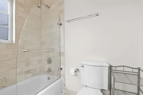 a bathroom with a bathtub and a shower