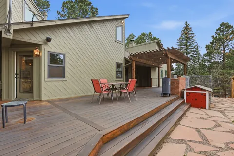 an aerial view of a house with table and chairs