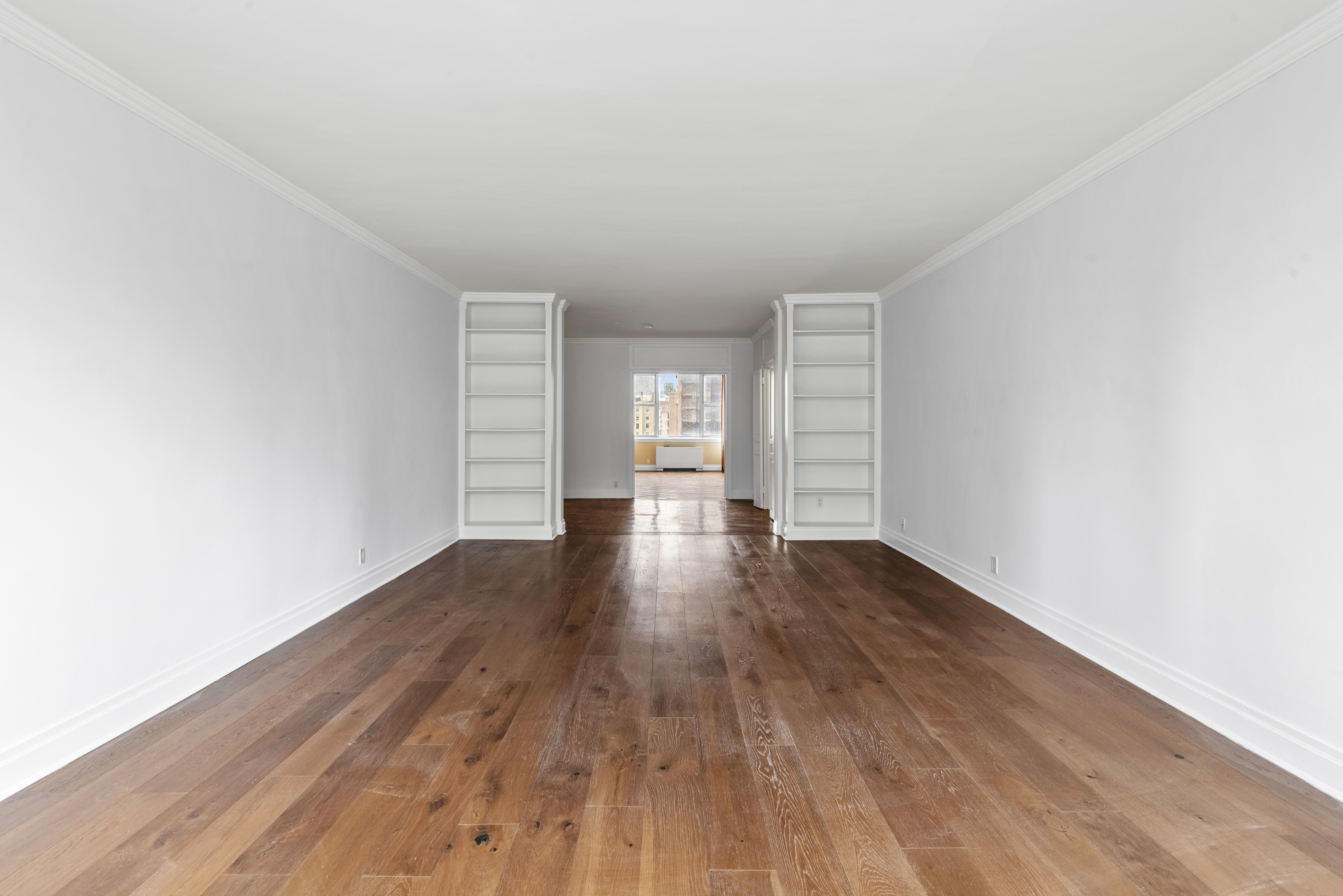 175 East 62nd Street, Unit 12A Manhattan, NY 10065 - Photo 20 of 24 a view of empty room with wooden floor and fan