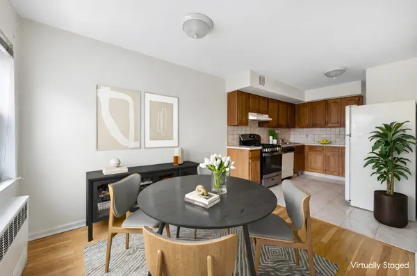 a kitchen with granite countertop a dining table chairs and a stove