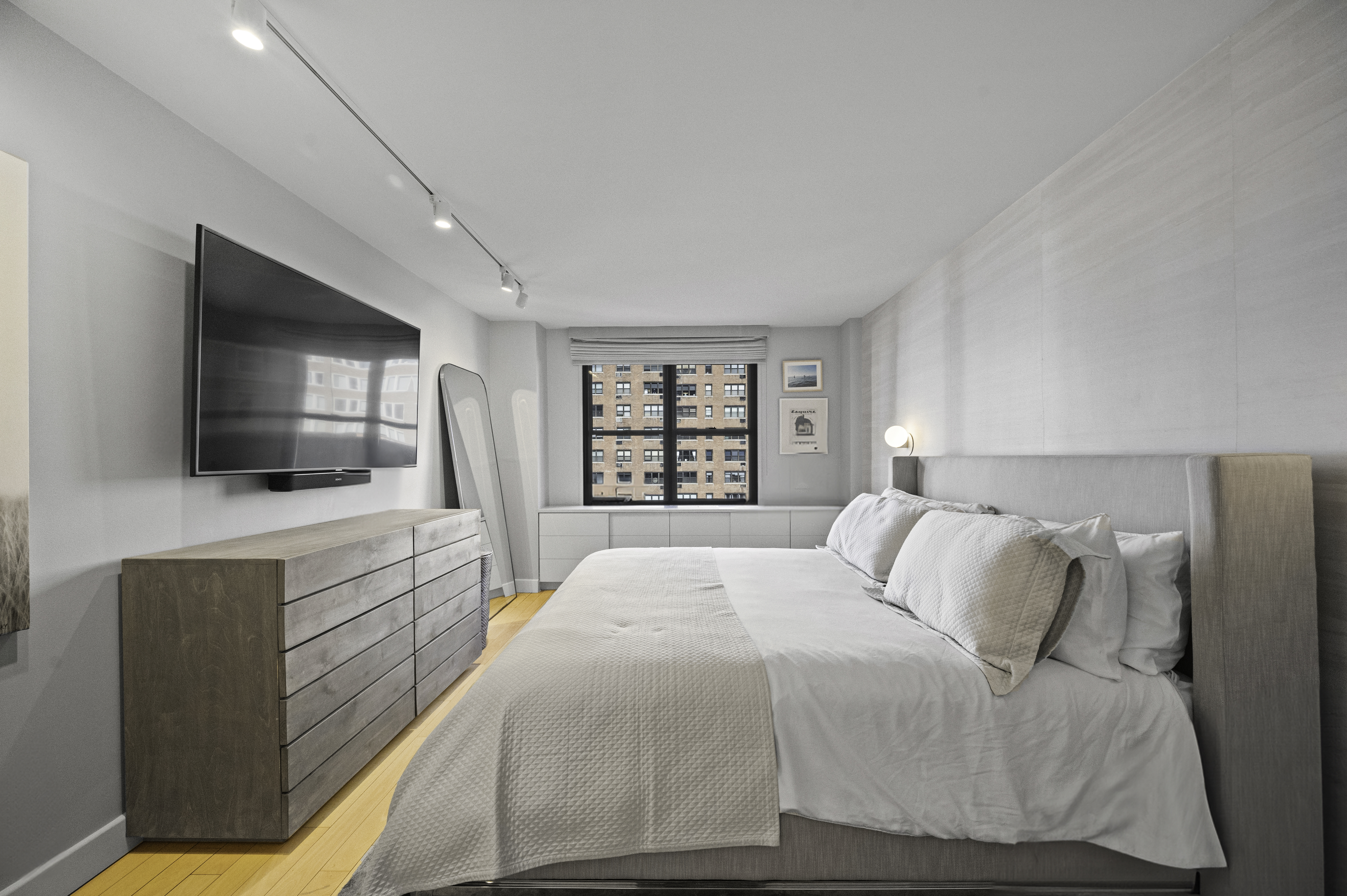 301 East 62nd Street, Unit 7K Manhattan, NY 10065 - Photo 4 of 14 a spacious bedroom with a large bed and a flat screen tv