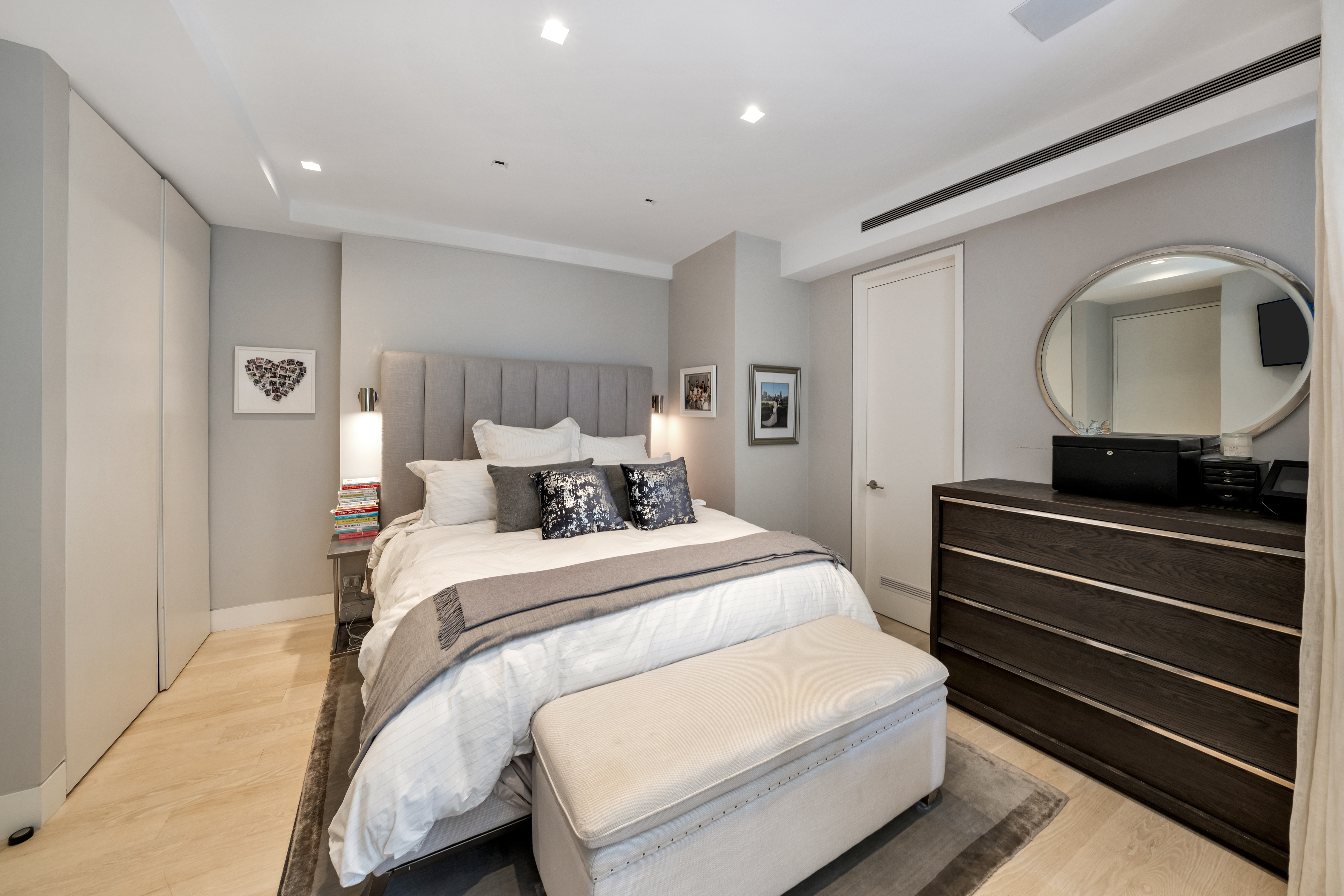 67 Park Avenue, Unit 2BC Manhattan, NY 10016 - Photo 7 of 16 a bed room with a bed and a mirror