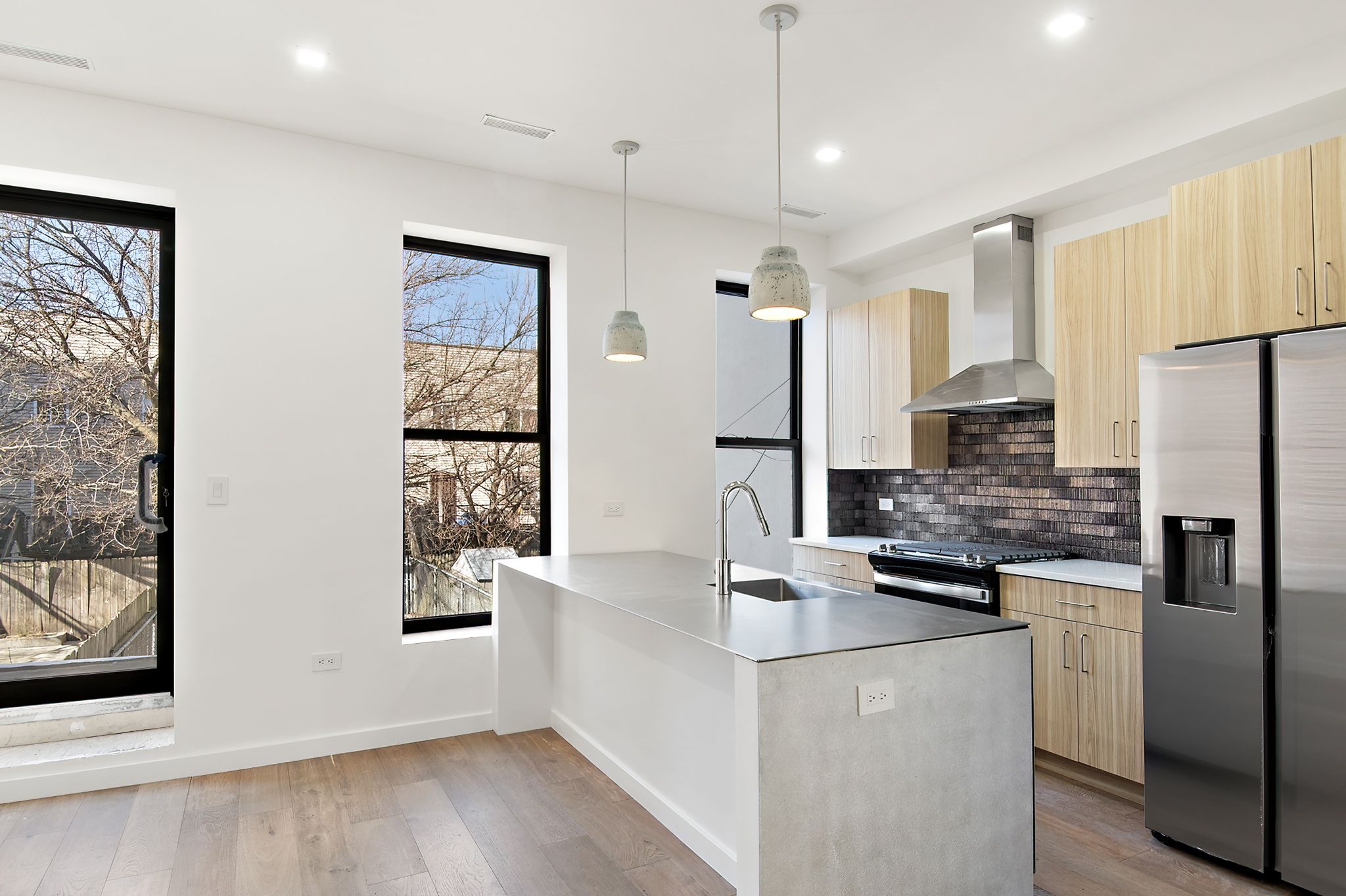 181 Kosciuszko Street Brooklyn, NY 11216 - Photo 4 of 20 a kitchen with stainless steel appliances granite countertop a refrigerator a sink dishwasher a oven with white cabinets and wooden floor